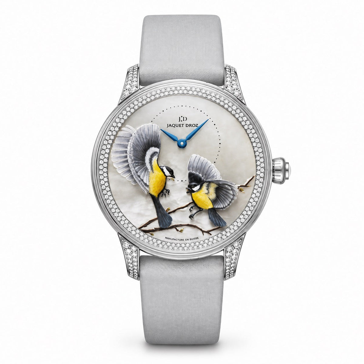 Jaquet Droz watch with a silver-tone case, stone-set bezel, dial depicting two birds on branches, blue hands, and a light grey strap.