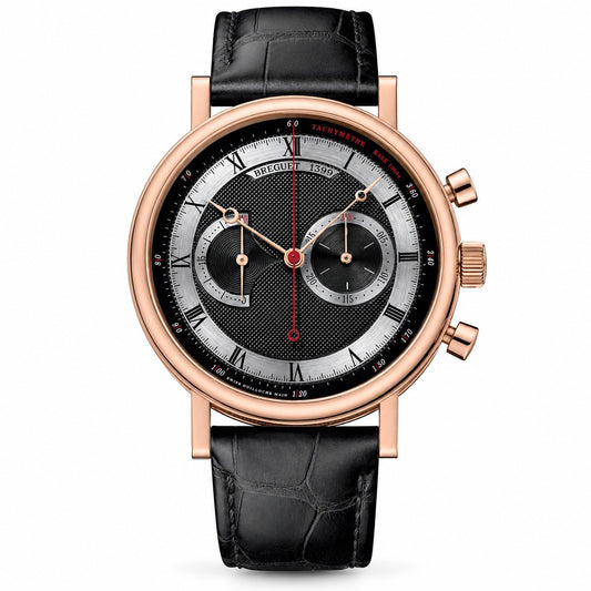 A luxury wristwatch with a round rose gold case, a black and silver dial featuring Roman numerals and two subdials, and a black crocodile-embossed leather strap.