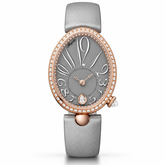 A luxury oval wristwatch with a textured gray strap, a gray dial, and a rose gold bezel accented with small clear crystals. The dial features stylized Arabic numerals and a teardrop-shaped crystal detail at the 6 o'clock position.