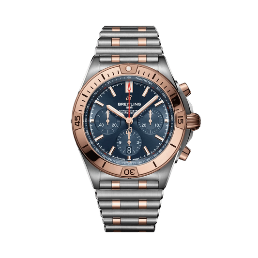 Breitling Chronomat chronograph watch with a blue dial, three subdials, rose gold tone bezel and accents, date display and two-tone metal bracelet.