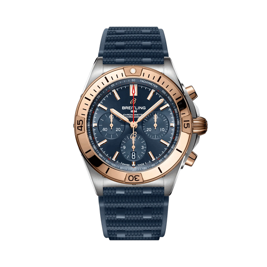 Breitling Chronomat chronograph watch with a blue dial, three blue subdials, rose gold tone bezel and accents, date display and textured blue strap.