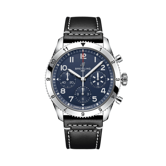 Breitling chronograph watch with a blue dial, three subdials, Arabic numerals, numbered silver tone bezel and black strap with white stitching.