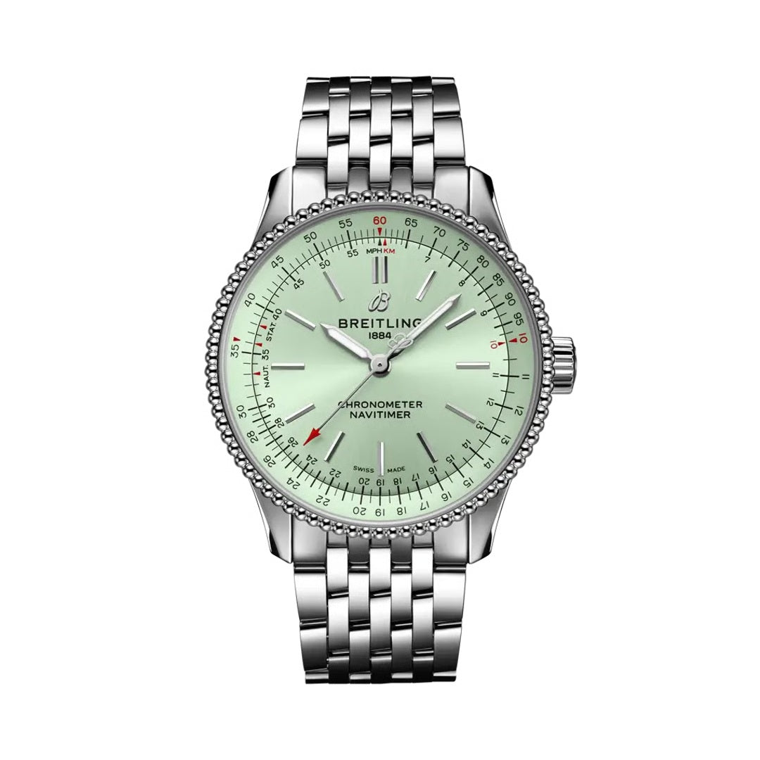 A Breitling Navitimer chronometer watch with a silver stainless steel link bracelet, a silver beaded bezel, and a pale mint green dial with white hands and red accents.