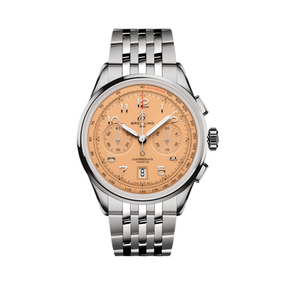 Breitling chronograph watch with a salmon dial, two matching subdials, silver Arabic numerals, date display, silver tone case and metal link bracelet.