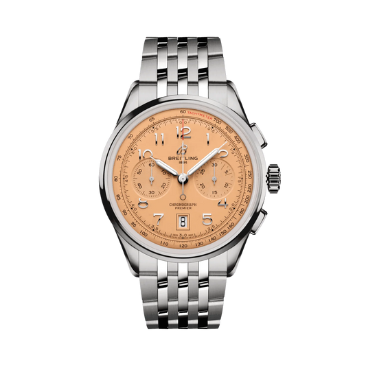 Breitling chronograph watch with a salmon dial, two matching subdials, silver Arabic numerals, date display, silver tone case and metal link bracelet.