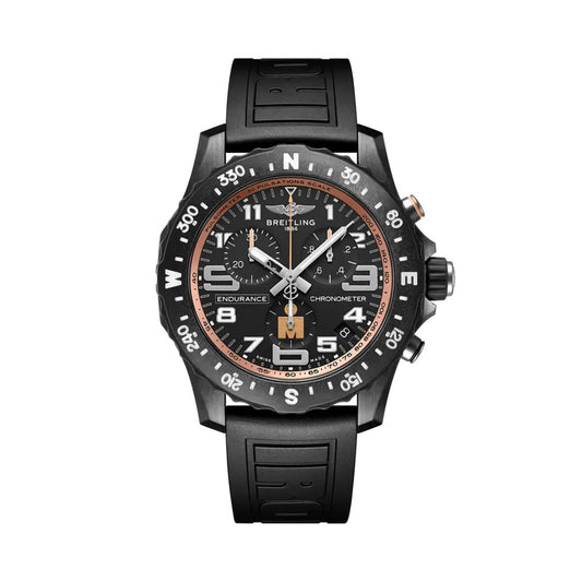 Breitling Endurance Pro chronograph watch featuring a black dial, black compass bezel, three chronograph subdials, luminous numerals, bronze-orange accents, date display, and black rubber strap.