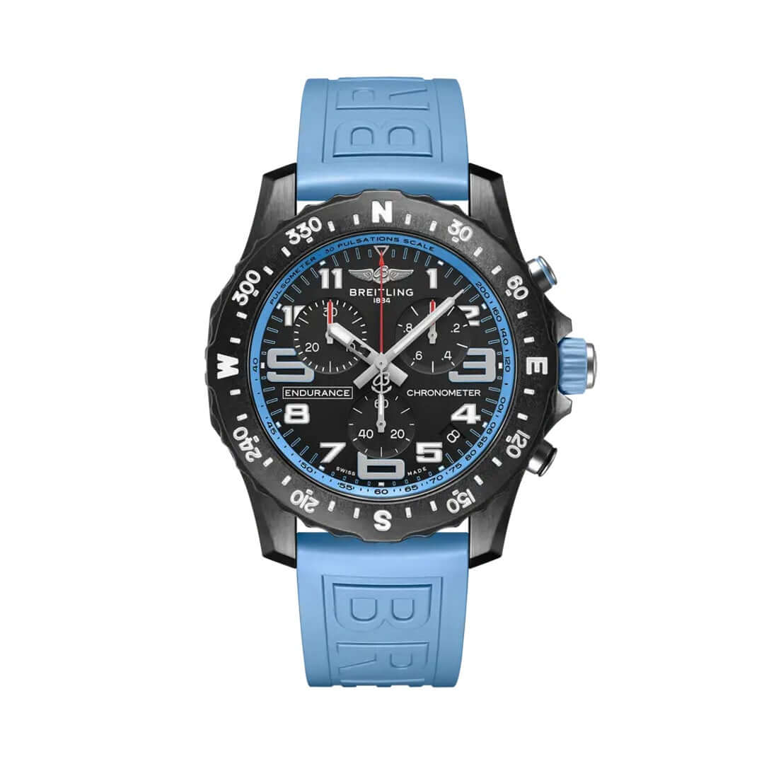 Breitling Endurance Pro chronograph watch featuring a black dial, black compass bezel, blue accents, three chronograph subdials, date display, luminous hour markers, and light blue rubber strap.