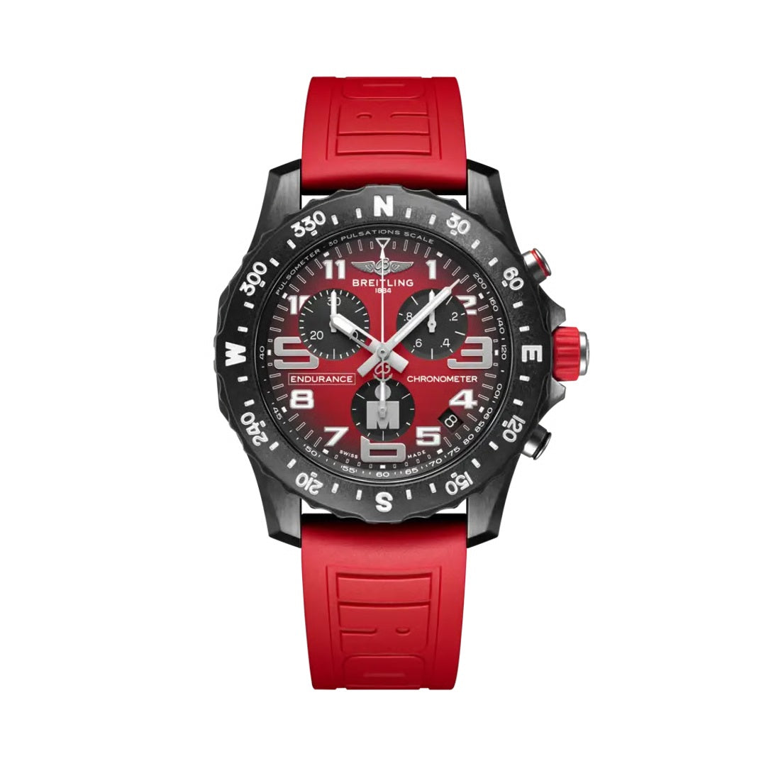 Breitling Endurance Pro chronograph watch featuring a red dial, black compass bezel, three chronograph subdials, luminous numerals, red accents, date display, and matching red rubber strap.