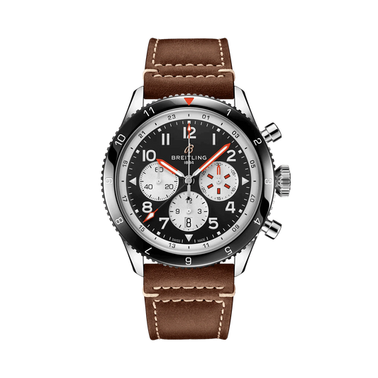 Breitling chronograph watch with a black dial, three silver subdials, red accents, Arabic numerals, black numbered bezel and brown strap with white stitching.