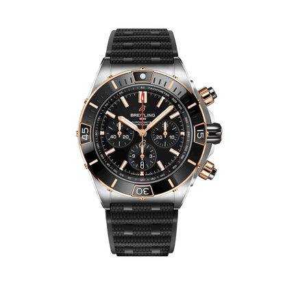 Breitling Chronomat chronograph watch with a black dial, three black subdials, rose gold tone accents, date display and textured black strap.