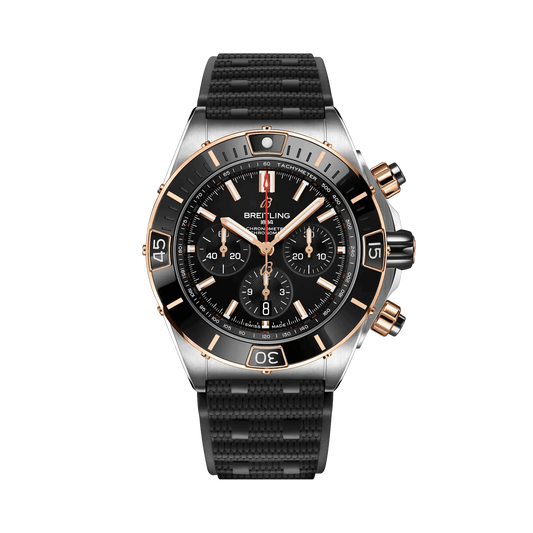 Breitling Chronomat chronograph watch with a black dial, three black subdials, rose gold tone accents, date display and textured black strap.
