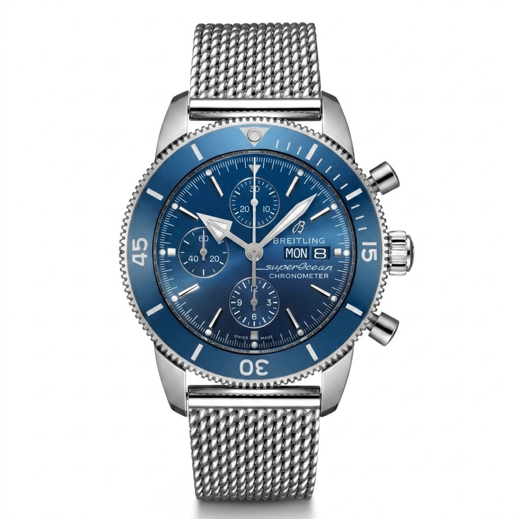Breitling Superocean Heritage Chronograph 44 wristwatch featuring a stainless steel case, blue dial with three silver sub-dials, day and date window at 3 o'clock, blue ceramic unidirectional bezel, and stainless steel mesh bracelet.