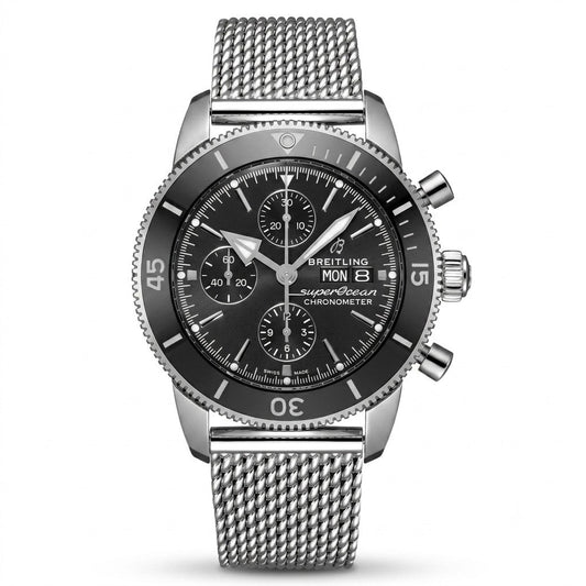 Breitling Superocean Heritage luxury chronograph watch featuring a black dial with three subdials, silver-tone hands and hour markers, black rotating bezel, stainless steel case, day-date display, and stainless steel mesh bracelet.