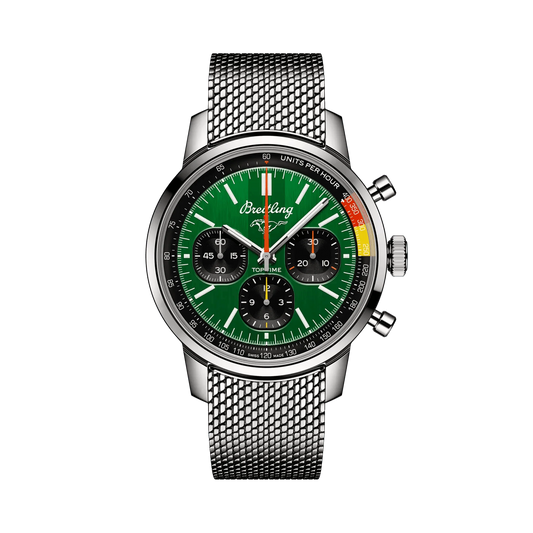 Breitling chronograph watch with a green dial, three black subdials, orange and yellow scale accents, silver tone case and mesh metal bracelet.