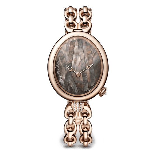 Oval watch with a dark patterned dial, rose gold-tone case, and double-row chain bracelet.