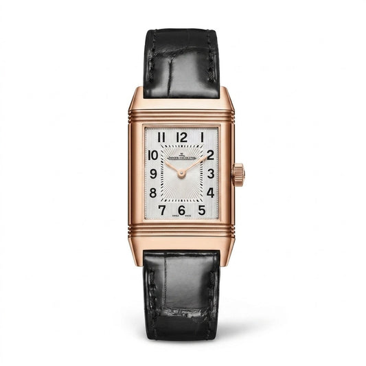 Jaeger-LeCoultre Reverso watch with a rectangular rose gold-tone case, silver dial with black Arabic numerals, and black leather strap.