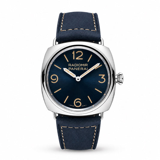 Panerai Radiomir watch with a dark blue dial, gold-tone numerals, silver-tone cushion case, and navy strap with beige stitching.