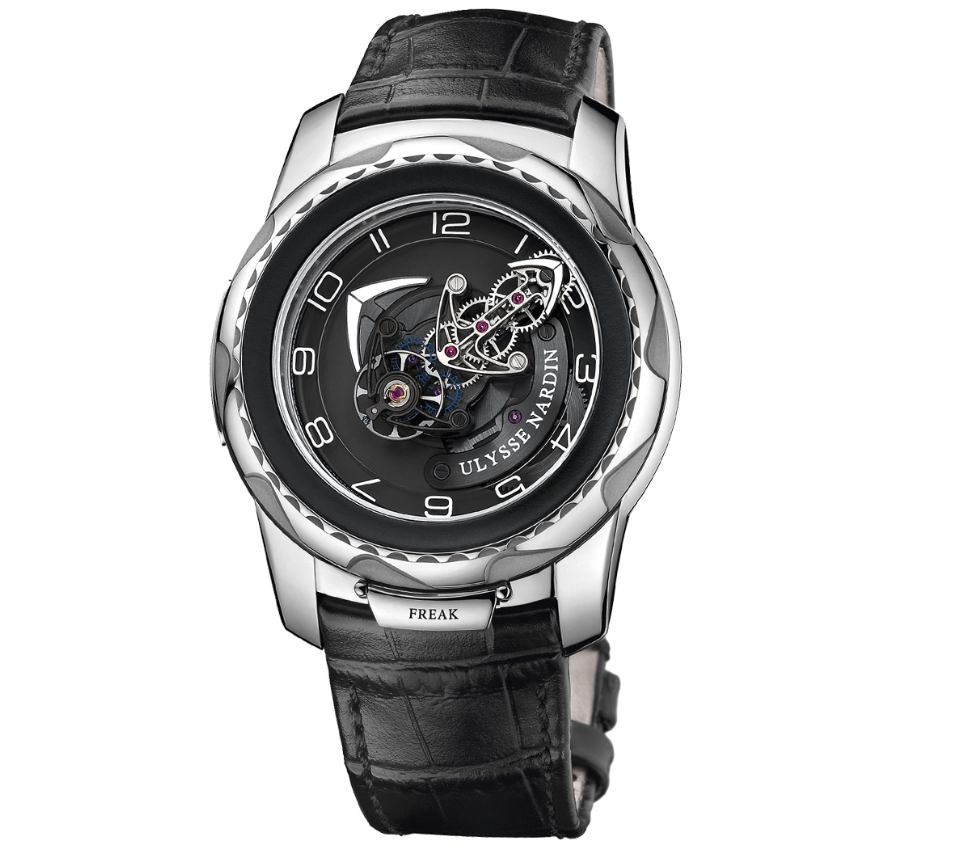 Ulysse Nardin Freak watch with a black dial, exposed central mechanism, silver tone Arabic numerals, polished silver tone case and black leather strap.